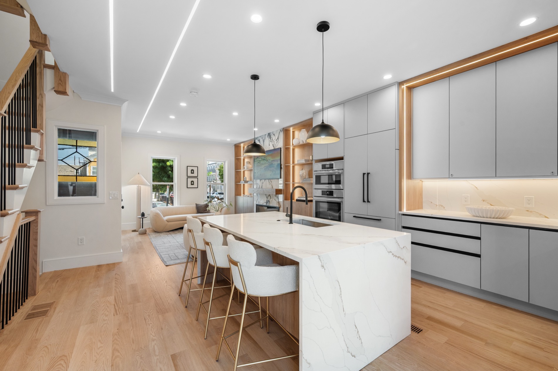 Main level of 39 G Street, looking from the kitchen island through to the living room and front windows